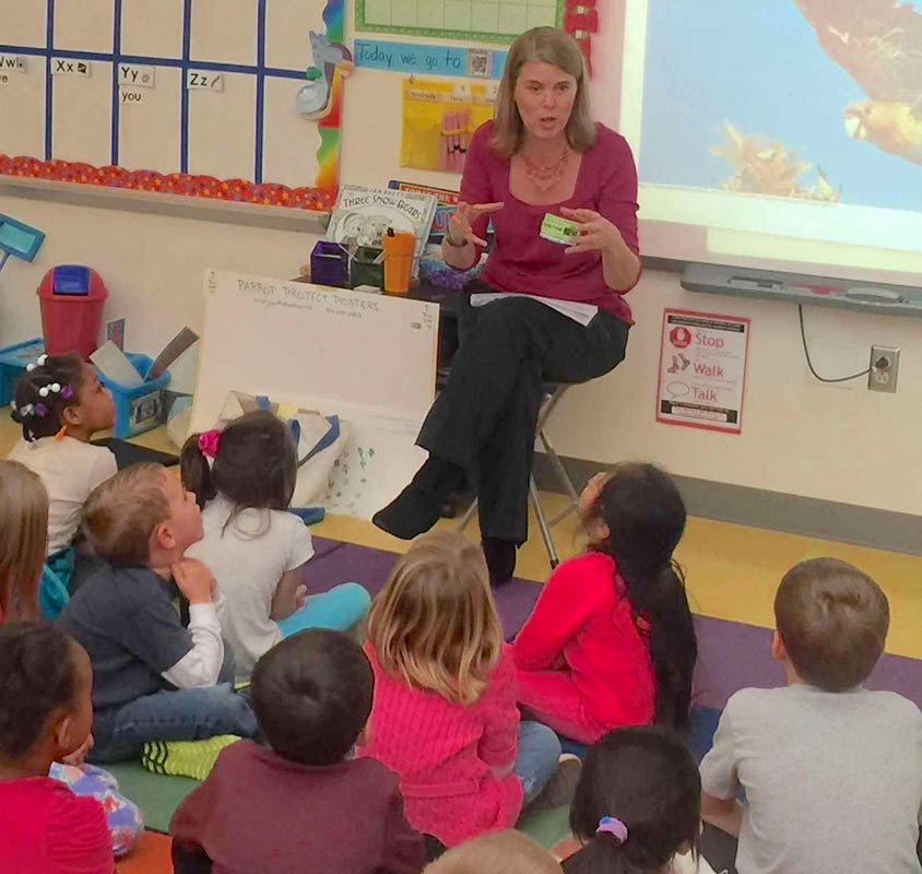 Photo of Kristi J. Smith speaking to a group of children