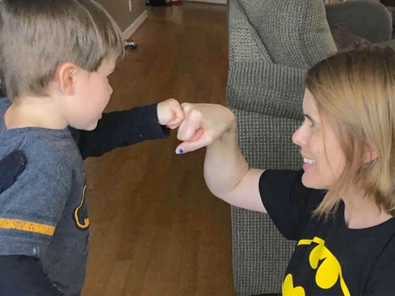 Photo of Kristi giving a fist bump to her son